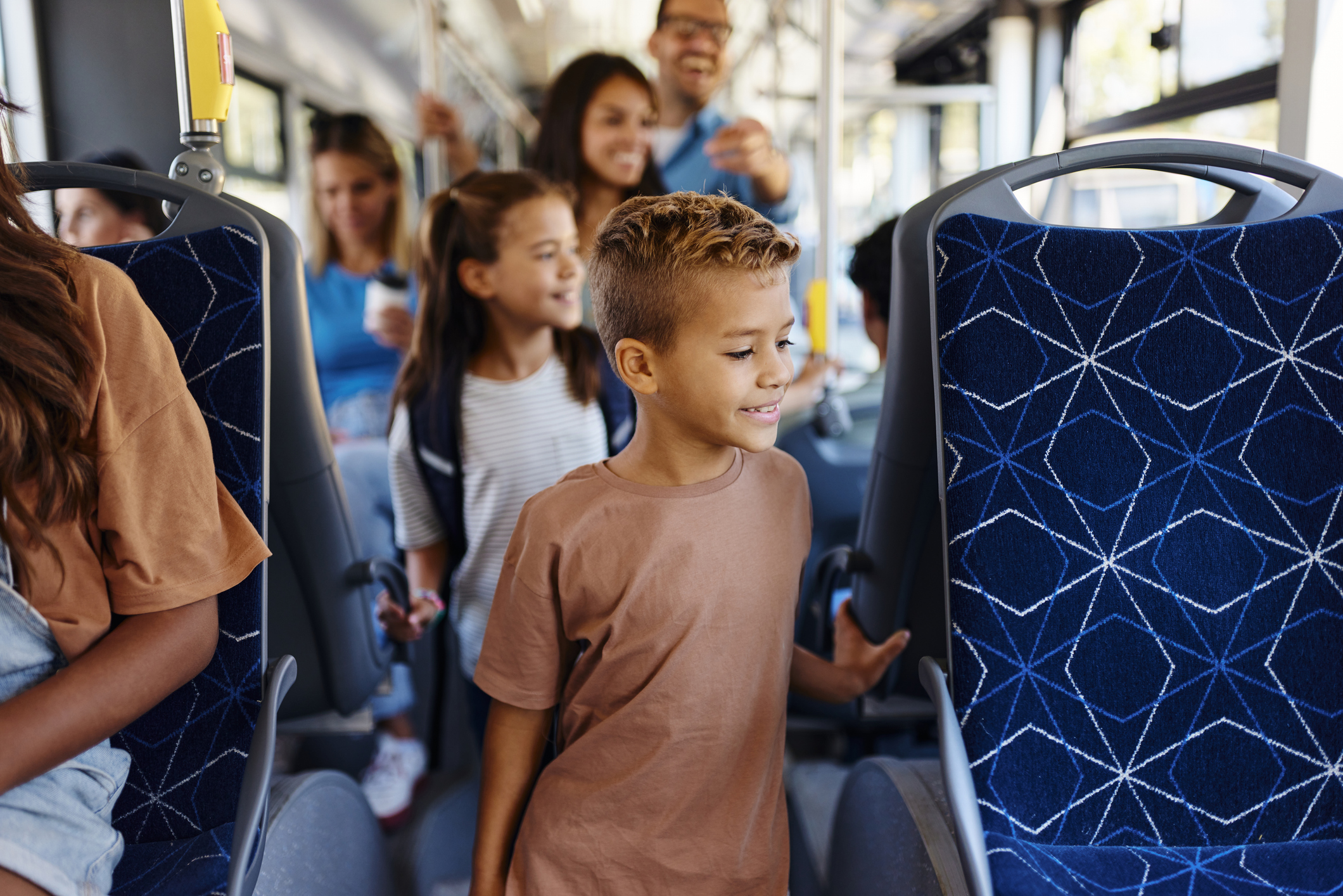 Smiling diverse group of riders inside a unspecific transit vehicle